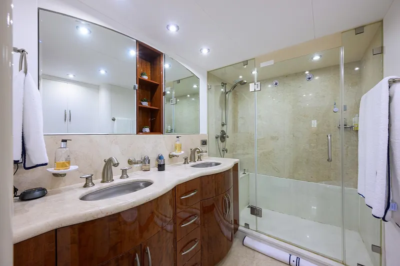 Slide: The Image of Luxurious bathroom in 2005 Lazzara 68 Enclosed Bridge yacht with glass shower and double sink. - 57