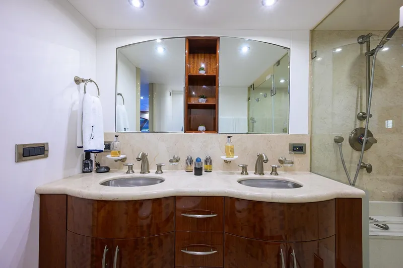 Slide: The Image of Luxurious bathroom in 2005 Lazzara 68 Enclosed Bridge yacht with dual sinks and elegant fixtures. - 58