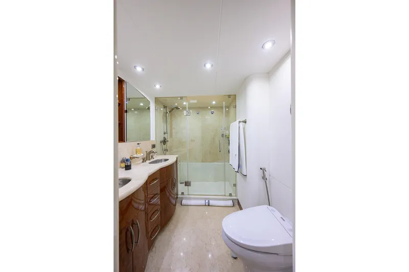 Slide: The Image of Luxurious bathroom in 2005 Lazzara 68 Enclosed Bridge yacht with modern fixtures and glass shower. - 59