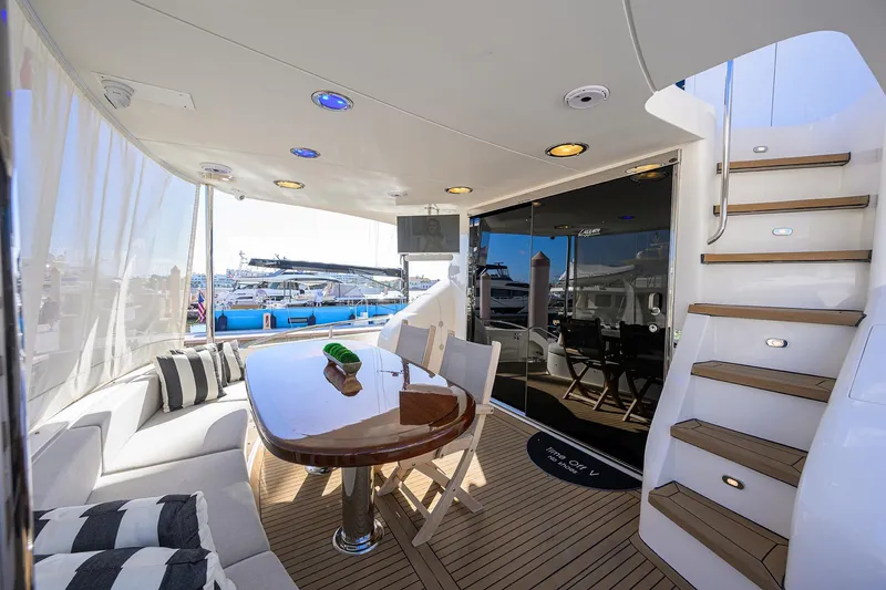 Slide: The Image of Luxurious 2005 Lazzara 68 Enclosed Bridge yacht interior with elegant seating and dining area. - 6