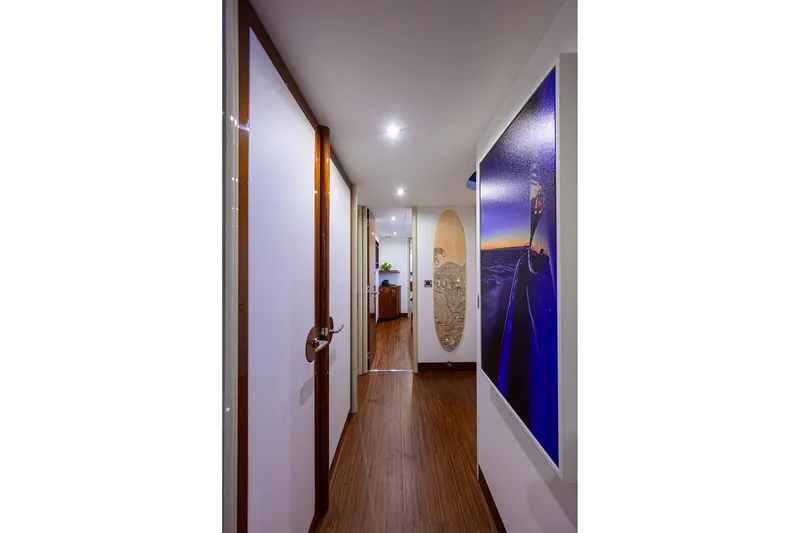 Slide: The Image of Hallway of 2005 Lazzara 68 Enclosed Bridge yacht with modern decor and artwork. - 60