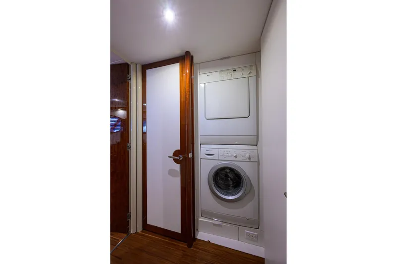Slide: The Image of Laundry area with stacked washer and dryer in 2005 Lazzara 68 Enclosed Bridge yacht. - 61