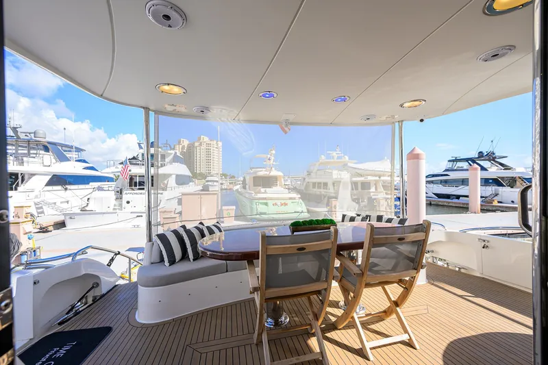 Slide: The Image of Luxurious 2005 Lazzara 68 Enclosed Bridge yacht with elegant outdoor seating at marina. - 7