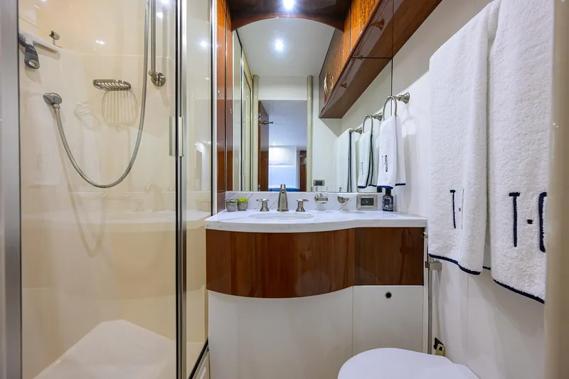 Slide: The Image of Luxurious bathroom in 2005 Lazzara 68 Enclosed Bridge yacht with modern fixtures and elegant design. - 70