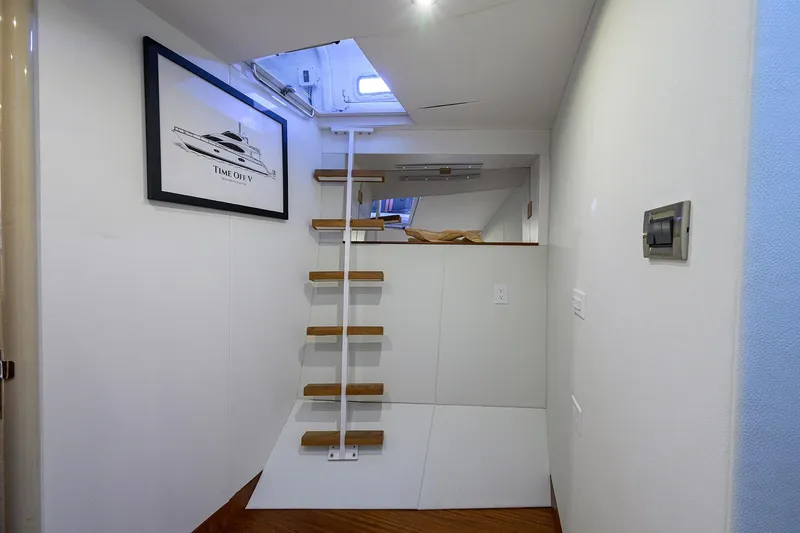 Slide: The Image of Interior of 2005 Lazzara 68 Enclosed Bridge yacht with ladder and framed artwork. - 75