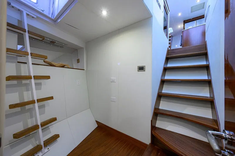 Slide: The Image of Interior of 2005 Lazzara 68 Enclosed Bridge yacht with wooden stairs and modern design. - 76