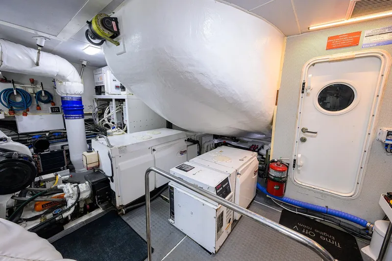 Slide: The Image of Engine room of 2005 Lazzara 68 Enclosed Bridge yacht, featuring equipment and safety gear. - 77