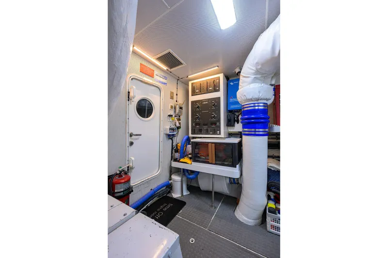 Slide: The Image of Engine room of 2005 Lazzara 68 Enclosed Bridge yacht, featuring control panels and equipment. - 78