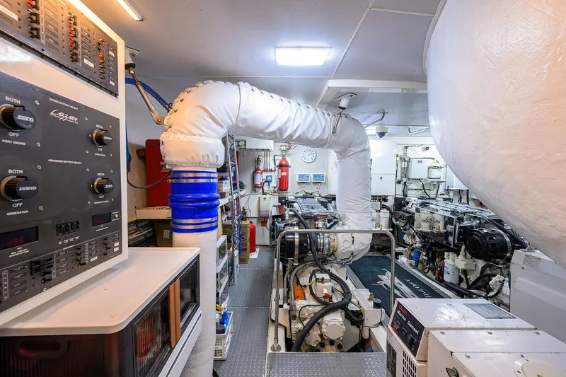 Slide: The Image of Engine room of 2005 Lazzara 68 Enclosed Bridge yacht, featuring control panels and machinery. - 79