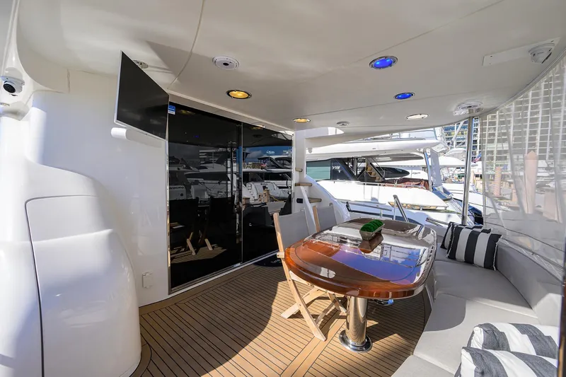 Slide: The Image of Luxurious 2005 Lazzara 68 Enclosed Bridge yacht with elegant outdoor seating and dining area. - 8