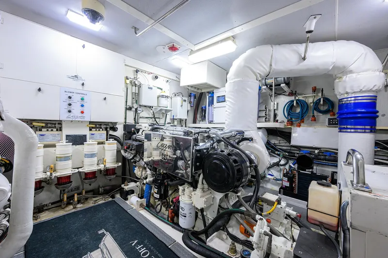 Slide: The Image of Engine room of 2005 Lazzara 68 Enclosed Bridge yacht, featuring advanced machinery and controls. - 81