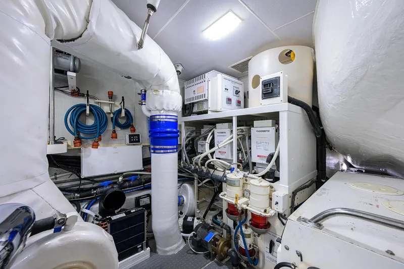 Slide: The Image of Engine room of 2005 Lazzara 68 Enclosed Bridge yacht, featuring advanced equipment and piping. - 82