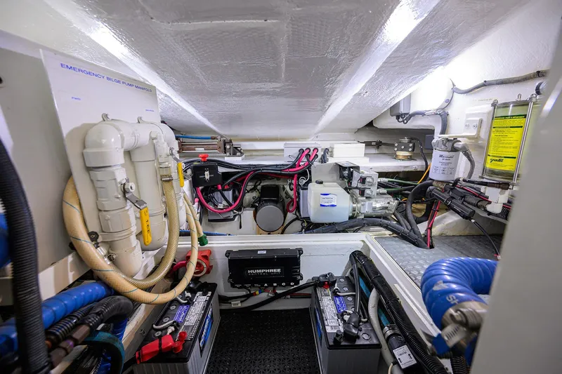 Slide: The Image of Engine room of 2005 Lazzara 68 Enclosed Bridge yacht, showcasing equipment and wiring. - 87