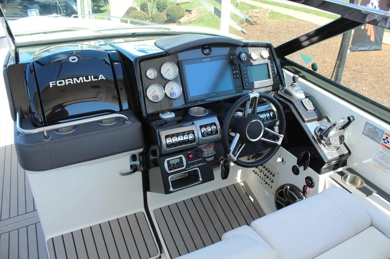 Slide: The Image of 2018 Formula 350 Crossover Bowrider helm with modern controls and navigation displays. - 14