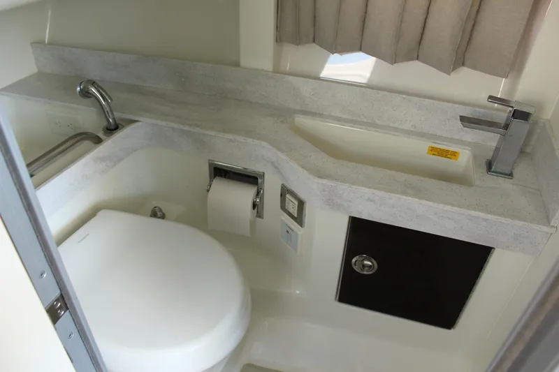 Slide: The Image of 2018 Formula 350 Crossover Bowrider bathroom with modern sink and toilet. - 21