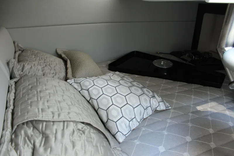 Slide: The Image of 2018 Formula 350 Crossover Bowrider cabin interior with cozy bedding and pillows. - 23