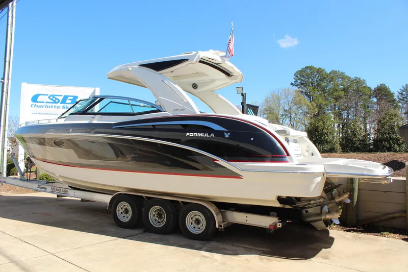 Slide: The Image of 2018 Formula 350 Crossover Bowrider on trailer, displayed outdoors under clear blue sky. - 4