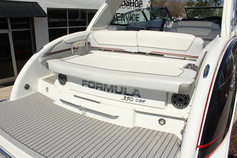 Slide: The Image of 2018 Formula 350 Crossover Bowrider boat with spacious seating and sleek design. - 7