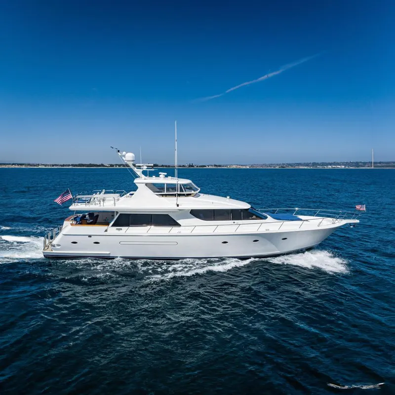 The Image of 2001 West Bay Sonship yacht cruising on open water under clear blue skies. - 0