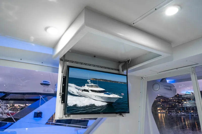 Slide: The Image of 2001 West Bay Sonship yacht interior with TV displaying yacht on water. - 12