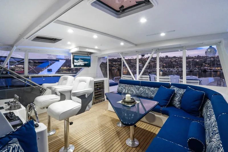 Slide: The Image of Luxurious 2001 West Bay Sonship yacht interior with elegant seating and scenic marina view. - 13