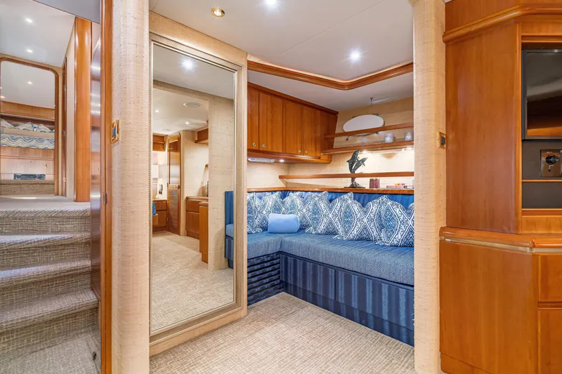 Slide: The Image of Luxurious interior of 2001 West Bay Sonship yacht with elegant wood finishes and blue seating. - 22