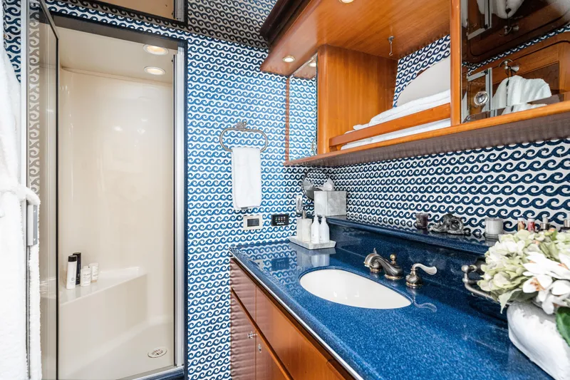 Slide: The Image of Luxurious 2001 West Bay Sonship yacht bathroom with blue wave-patterned walls and elegant fixtures. - 24