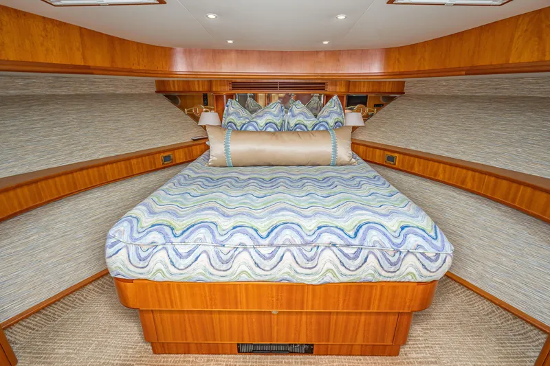 Slide: The Image of Luxurious 2001 West Bay Sonship yacht bedroom with patterned bedding and elegant wood finish. - 28