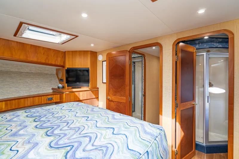 Slide: The Image of Luxurious 2001 West Bay Sonship yacht bedroom with wood accents and ensuite bathroom. - 29