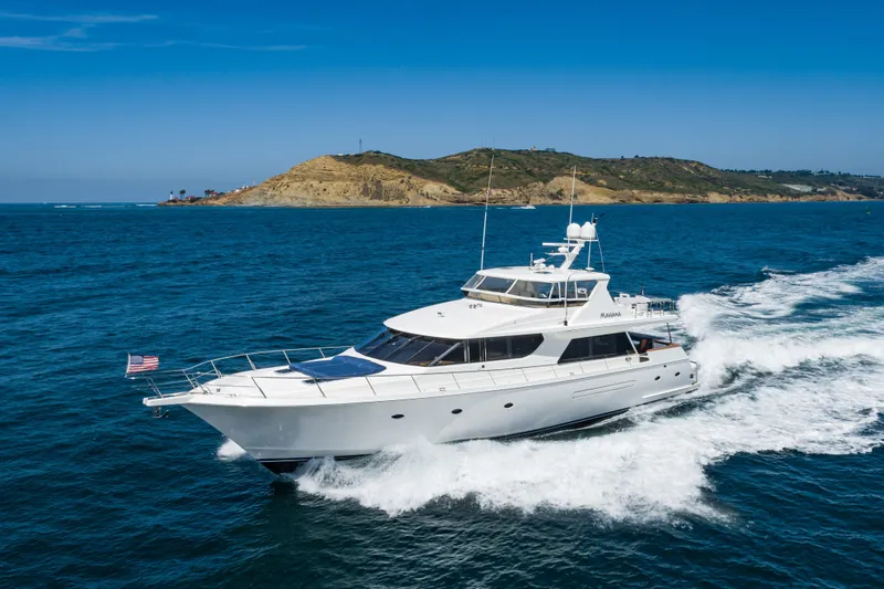 Slide: The Image of 2001 West Bay Sonship yacht cruising in open sea near a scenic coastline. - 3