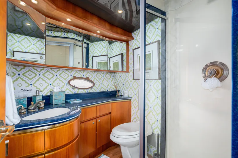 Slide: The Image of Luxurious 2001 West Bay Sonship yacht bathroom with elegant wood cabinetry and modern fixtures. - 31