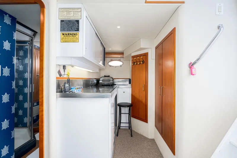 Slide: The Image of 2001 West Bay Sonship yacht interior with kitchenette, wooden cabinets, and nautical decor. - 33