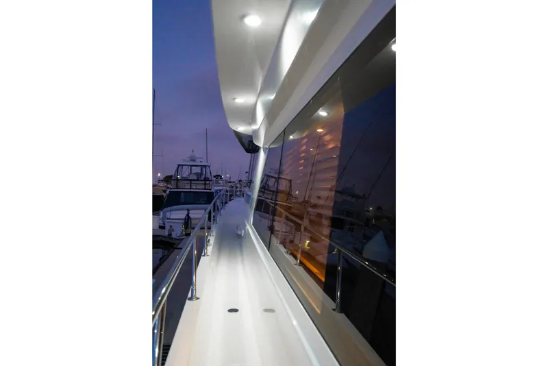 Slide: The Image of 2001 West Bay Sonship yacht deck at dusk, featuring sleek design and ambient lighting. - 35