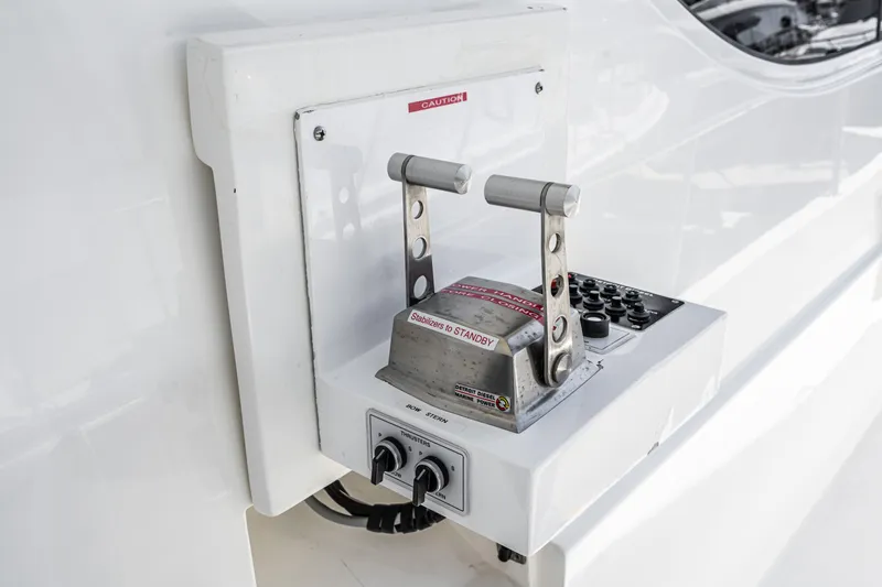 Slide: The Image of Control panel of 2001 West Bay Sonship yacht with dual levers and buttons. - 36