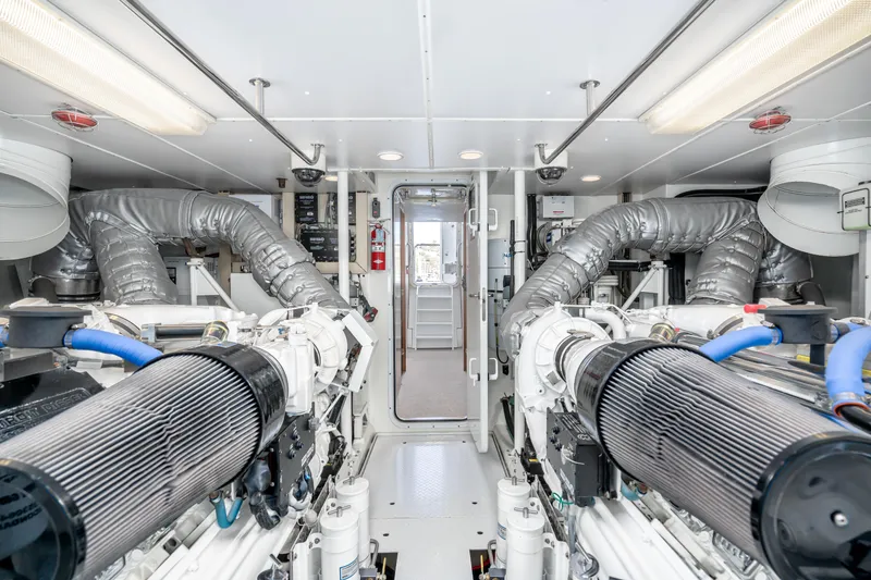 Slide: The Image of Engine room of 2001 West Bay Sonship yacht, featuring dual engines and ventilation systems. - 37