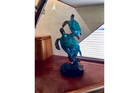 Slide: The Image of Glass sea turtle sculpture on a wooden surface inside a 2001 West Bay Sonship yacht. - 43