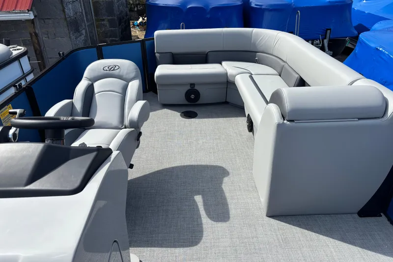Slide: The Image of 2026 Bentley Pontoons Legacy 220 Cruise XL interior with luxurious seating and steering console. - 10