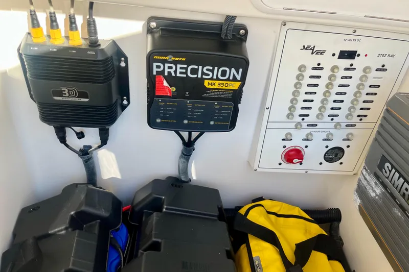 Slide: The Image of Control panel and equipment inside a 2018 SeaVee 270Z boat, featuring electronics and storage. - 17