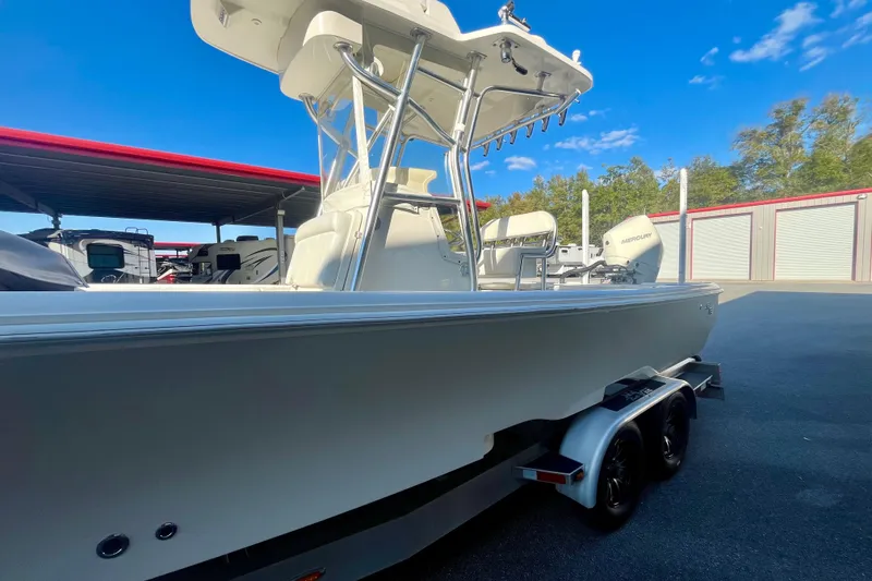 Slide: The Image of 2018 SeaVee 270Z boat on trailer, parked outdoors under clear blue sky. - 3