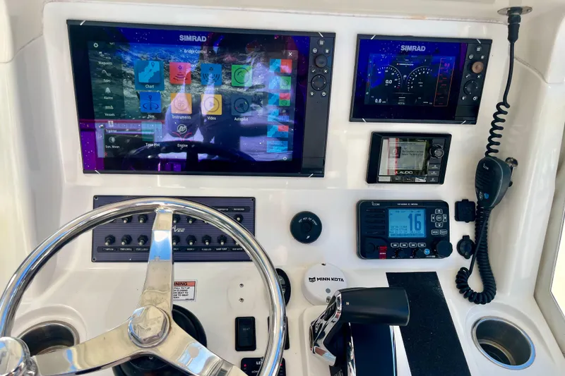 Slide: The Image of 2018 SeaVee 270Z boat dashboard with Simrad displays and navigation controls. - 6