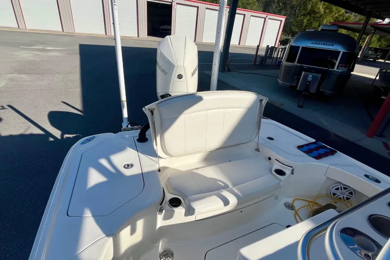 Slide: The Image of 2018 SeaVee 270Z boat with Mercury engine, featuring white seating and storage compartments. - 9