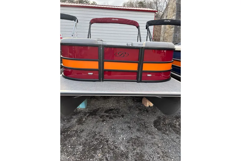 The Image of 2026 Bentley Pontoons Legacy 220 Cruise XL with red and orange accents, parked outdoors. - 0
