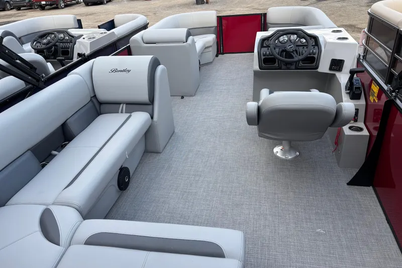 Slide: The Image of 2026 Bentley Pontoons Legacy 220 Cruise XL interior with luxurious seating and modern helm. - 10