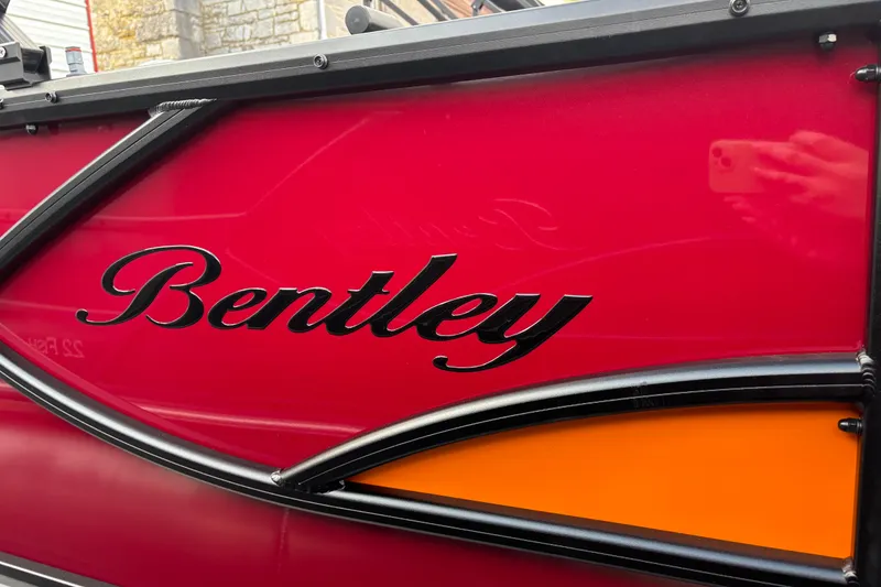 Slide: The Image of 2026 Bentley Pontoons Legacy 220 Cruise XL, red and orange exterior detail. - 2