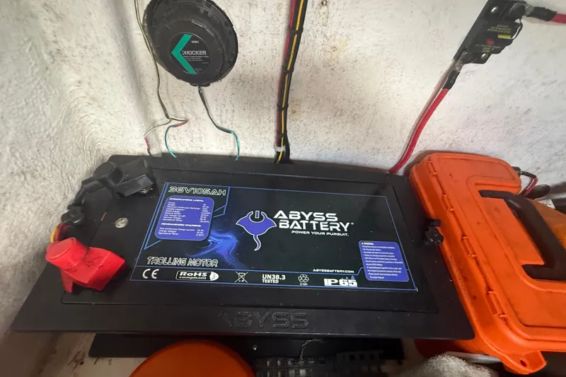 Slide: The Image of Abyss Battery setup in Eastward 30, 2022 model, featuring Kicker speaker and wiring. - 101