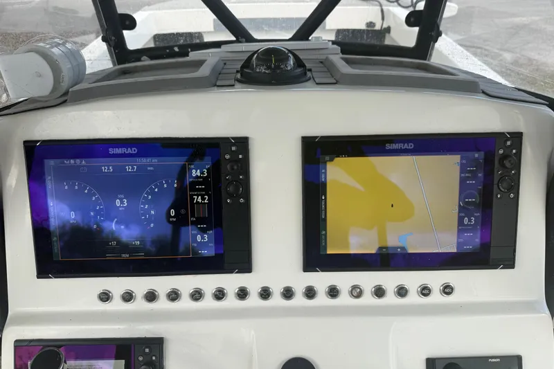 Slide: The Image of Simrad navigation displays on 2022 Eastward 30 boat dashboard, showing speed and map data. - 104