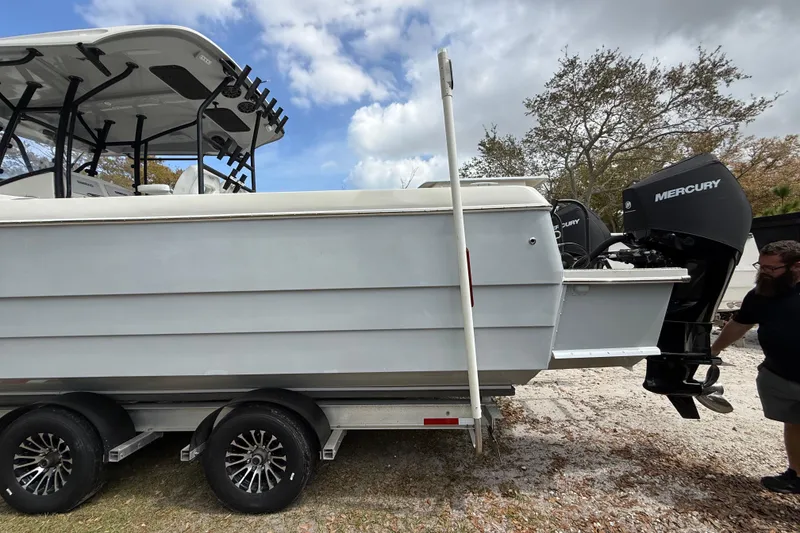 Slide: The Image of 2022 Eastward 30 boat on trailer with Mercury outboard engines, parked outdoors. - 11