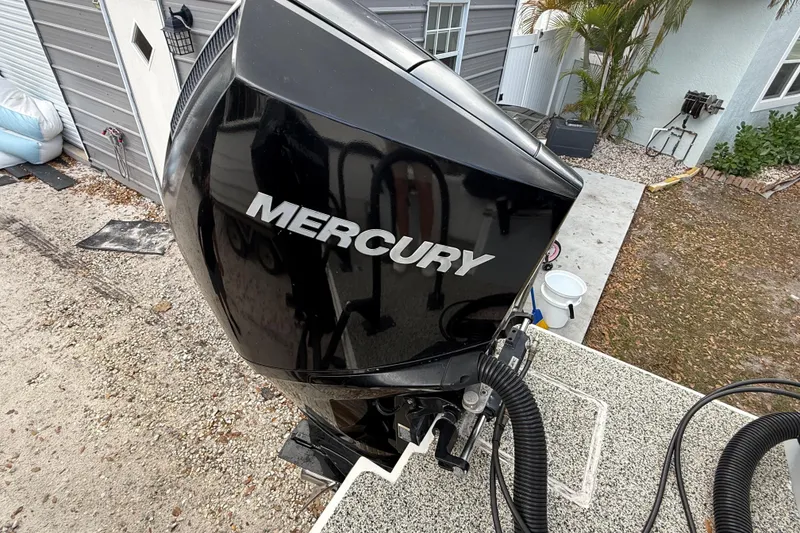 Slide: The Image of Mercury outboard motor on 2022 Eastward 30 boat, parked near a house. - 110