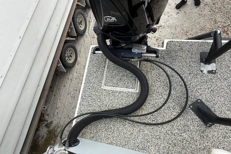 Slide: The Image of Top view of a 2022 Eastward 30 boat deck with motor and cables. - 112