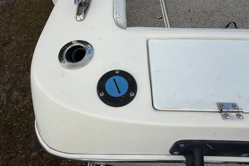Slide: The Image of Close-up of a 2022 Eastward 30 boat deck with fuel cap and storage hatch. - 117